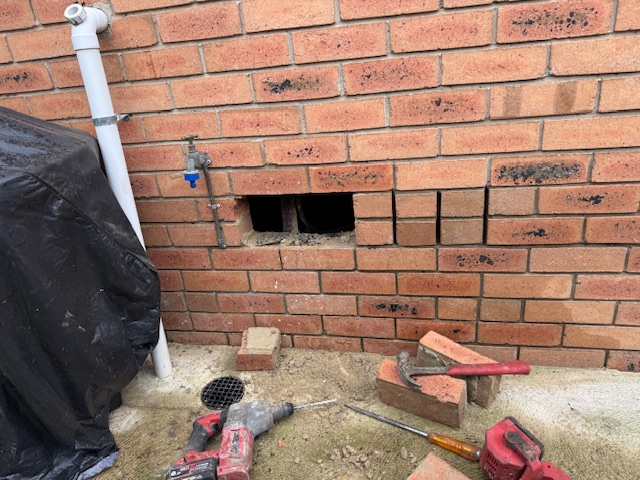 Brick wall access for plumbing repair Camberwell